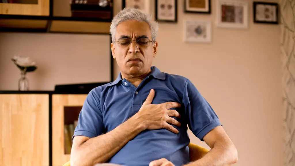 An old man holding his heart. 